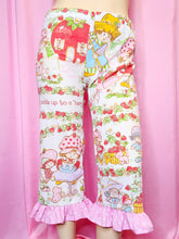 Load image into Gallery viewer, Patterned pants with ruffle hem against a pink background