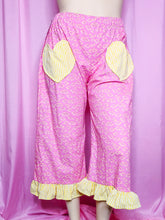 Load image into Gallery viewer, Pink pants with yellow accents on a pink background