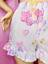 Load image into Gallery viewer, Shorts with princess and heart designs on a pink background