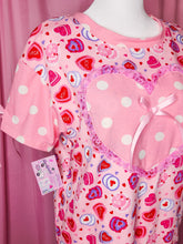 Load image into Gallery viewer, Pink tshirt with heart cake patterns on a pink background