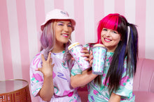 Load image into Gallery viewer, two pastel friends sharing a drink in front of a pink striped wall, wearing dog print dresses