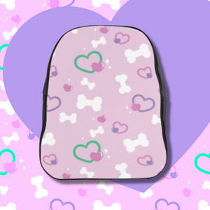 Black backpack with pink front panel with bone and heart print