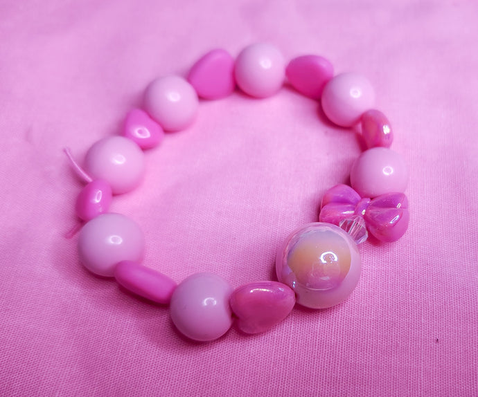 Pink fuchsia iridescent heart bow lovecore kandi stretch bracelet