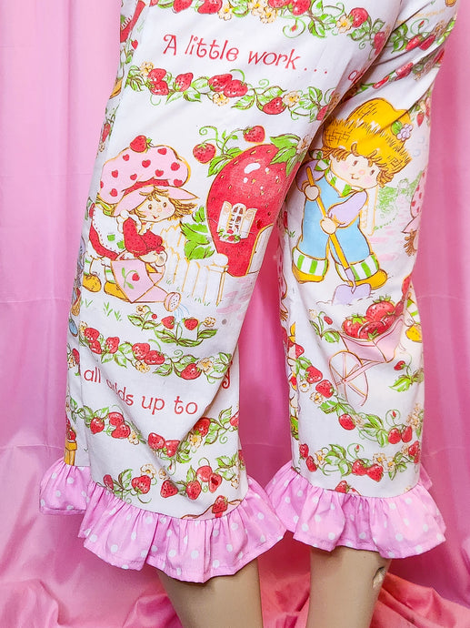 Capri pants with cartoon characters and strawberry pattern on a pink background