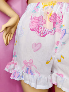 Shorts with princess and heart designs on a pink background