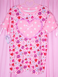 Pink t-shirt with heart and polka dot pattern on a pink background