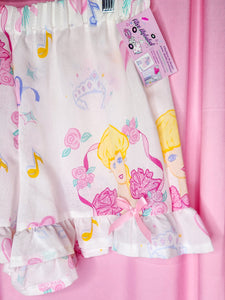 Ruffle shorts with cartoon character design on a pink background