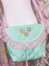 Load image into Gallery viewer, Pastel green handbag with pink ruffle and embroidered details on a colorful background