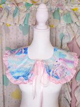 Load image into Gallery viewer, A pastel unicorn-print collar with pink ruffled trim and a pink ribbon bow, displayed on a white mannequin torso against a matching ruffled fabric backdrop.