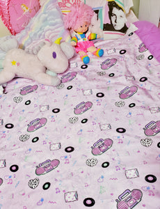barbie boombox blanket on bed with pillows and stuffed animals
