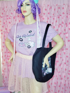 mannequin modeling Miss Alphabet t-shirt and black Miss Alphabet tote bag