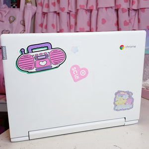 shiny sticker of a pink barbie style 90's boombox on a laptop