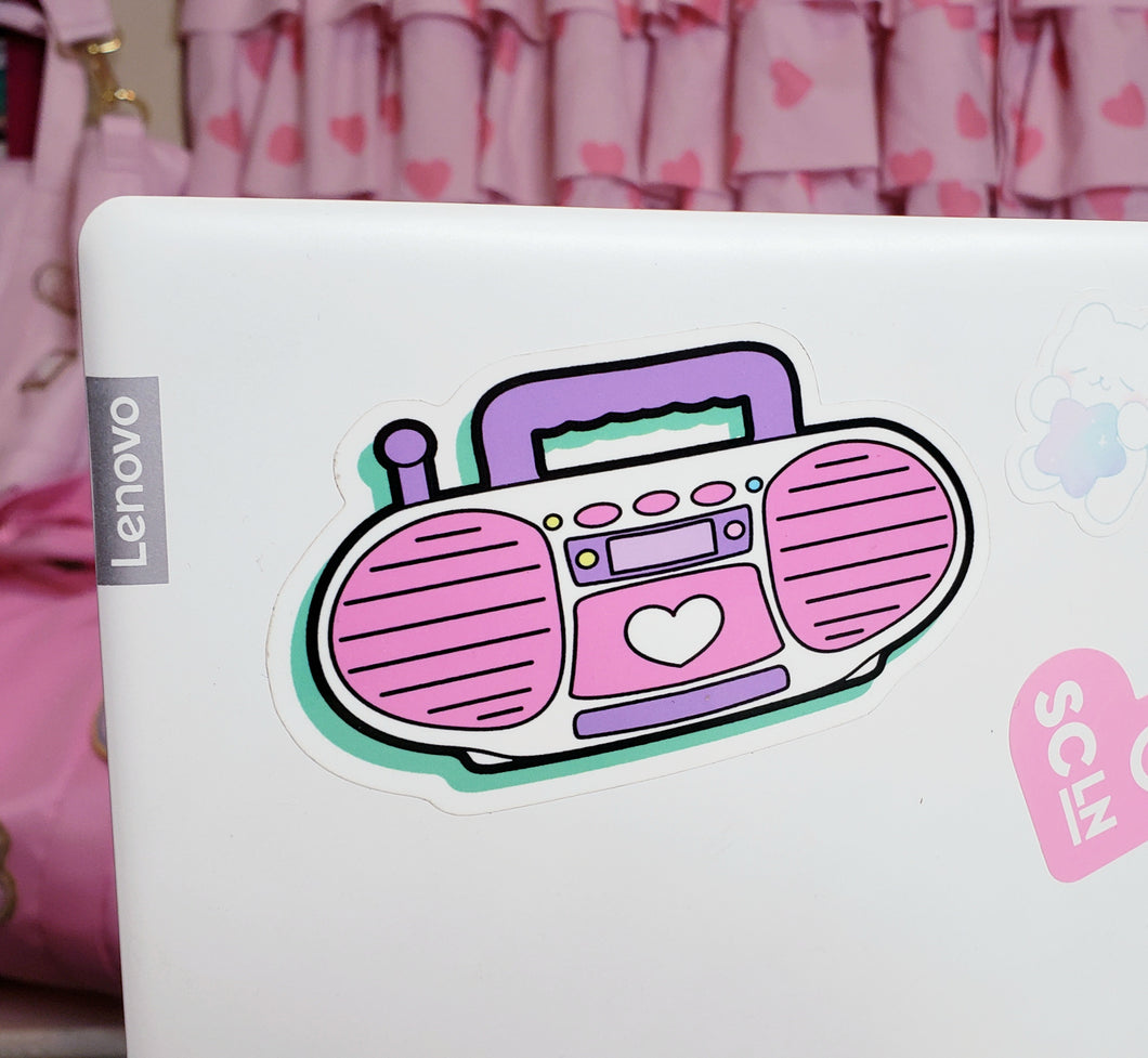 shiny sticker of a pink barbie style 90's boombox on a laptop