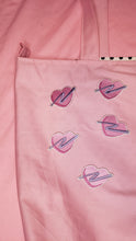 Load image into Gallery viewer, embroidered pink heart patches with purple swoosh on a pink tote bag