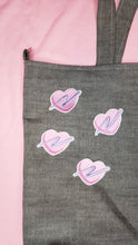 Load image into Gallery viewer, embroidered pink heart patches with purple swoosh on a denim tote bag