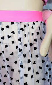 closeup of white mesh and black flocked hearts with pink elastic waistband