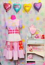 Load image into Gallery viewer, Valentine&#39;s themed patchwork jumperskirt on a mannequin against a pastel heart backdrop
