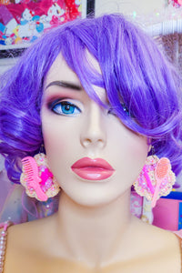 lavender haired mannequin modeling crochet earrings with barbie accessories