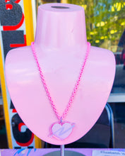 Load image into Gallery viewer, pink enamel chain necklace with pink and lavender glitter swoosh heart acrylic pendant on pink jewelry stand