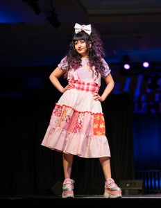 dark haired hispanic woman modeling a patchwork valentine's jumperskirt