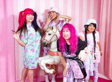 Load image into Gallery viewer, pastel colored friends modeling dog and bone print clothing and posing with a carousel horse against a pink and white striped wall