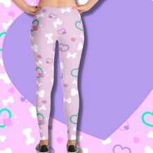 Load image into Gallery viewer, Back view of pink leggings with bone and heart print on model