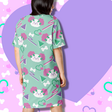 Load image into Gallery viewer, Back view of Mint green t-shirt dress with pink eared dog faces and geometric shapes in pink and purple on model