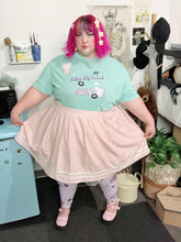 Load image into Gallery viewer, Femme with pink hair modeling mint green Miss Alphabet t-shirt and Barbie boombox leggings