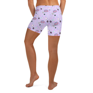 back view of model wearing lavender biking shorts with pink boombox motif